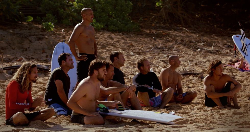 Surfers looking out at waves